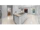 A modern kitchen is centered by a granite island cooktop and complimented by elegant white cabinets at 101 Abbotsford Ct, Durham, NC 27712
