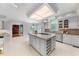 Bright, spacious kitchen boasts an island, granite counters, wine rack and white cabinets at 101 Abbotsford Ct, Durham, NC 27712