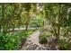 Brick path lined with lush landscaping and mature trees for a serene atmosphere at 101 Abbotsford Ct, Durham, NC 27712
