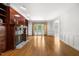 Spacious living room featuring a fireplace, built-in shelves, and French doors leading to the deck at 101 Abbotsford Ct, Durham, NC 27712