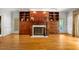 Elegant living room with a fireplace, hardwood floors, and built-in shelving at 101 Abbotsford Ct, Durham, NC 27712