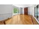 Living room features hardwood floors, wainscoting, a bay window, and built-in cabinet at 101 Abbotsford Ct, Durham, NC 27712