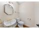 Charming powder room featuring elegant fixtures, a decorative mirror, and wallpaper at 101 Abbotsford Ct, Durham, NC 27712