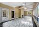Relaxing sun room features multiple windows, a fireplace, and elegant marble tile flooring at 101 Abbotsford Ct, Durham, NC 27712