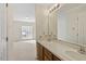 Bathroom featuring double sinks, a long mirror, and plenty of light and access to bedroom at 101 Pickett Ln, Cary, NC 27511