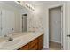 Bathroom featuring double sinks, a long mirror, and plenty of light and access to toilet area at 101 Pickett Ln, Cary, NC 27511