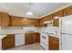 Traditional kitchen with wood cabinetry and white appliances at 101 Pickett Ln, Cary, NC 27511
