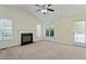 Bright living room featuring a fireplace, ample windows, and neutral carpeting at 101 Pickett Ln, Cary, NC 27511