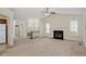 Inviting living room with fireplace, large windows, and access to kitchen at 101 Pickett Ln, Cary, NC 27511