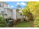Back of home featuring a staircase leading to a deck, and surrounded by greenery at 101 Pickett Ln, Cary, NC 27511