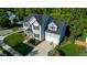 A beautiful two-story home with a dark roof and a manicured front lawn surrounded by mature trees at 101 Worsham Dr, Chapel Hill, NC 27516