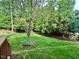 Well-maintained backyard featuring a lush lawn, mature trees, and neatly landscaped garden beds, offering a peaceful retreat at 101 Worsham Dr, Chapel Hill, NC 27516