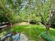 Beautifully landscaped backyard with a stone patio, fire pit, and lush greenery, creating a relaxing and inviting outdoor oasis at 101 Worsham Dr, Chapel Hill, NC 27516