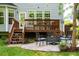 Cozy backyard retreat with a stone patio, fire pit, and well-maintained deck, perfect for outdoor entertaining and relaxation at 101 Worsham Dr, Chapel Hill, NC 27516