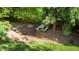 The backyard features a wooden picnic table set on mulch surrounded by lush greenery at 101 Worsham Dr, Chapel Hill, NC 27516