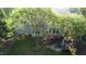 A high angle of the backyard showing a stone patio with seating, a wooden deck, and a well-manicured lawn at 101 Worsham Dr, Chapel Hill, NC 27516