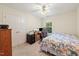 Cozy bedroom with a ceiling fan, a workspace, and a comfortable patterned bed at 101 Worsham Dr, Chapel Hill, NC 27516