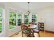 Bright breakfast nook with large windows and a view of the landscaped backyard at 101 Worsham Dr, Chapel Hill, NC 27516