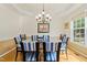 Formal dining room with elegant lighting, and a glass table for sophisticated dining at 101 Worsham Dr, Chapel Hill, NC 27516