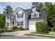 A charming two-story home with gray siding, a well-manicured lawn, and a driveway leading to an attached garage at 101 Worsham Dr, Chapel Hill, NC 27516