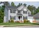 Charming two-story home featuring gray siding, black shutters, well-manicured lawn, and attached garage at 101 Worsham Dr, Chapel Hill, NC 27516