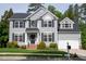 Beautiful two-story home with grey siding, black shutters, manicured lawn and attached garage at 101 Worsham Dr, Chapel Hill, NC 27516