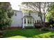 The rear exterior showcases a two-story home with a deck and a bay window, set against a backdrop of mature trees at 101 Worsham Dr, Chapel Hill, NC 27516