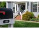 Charming front porch with decorative details, a mailbox, and manicured landscaping at 101 Worsham Dr, Chapel Hill, NC 27516