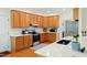 Well-lit kitchen with wood cabinets, stainless steel appliances, and quartz countertops at 101 Worsham Dr, Chapel Hill, NC 27516