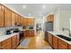Spacious kitchen featuring warm wood cabinets, white counters, and stainless steel appliances at 101 Worsham Dr, Chapel Hill, NC 27516