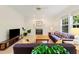 Bright living room featuring a fireplace and windows overlooking the backyard at 101 Worsham Dr, Chapel Hill, NC 27516