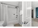 Bathroom featuring a shower over tub with white tile and a white shower curtain at 1016 Pemberly Ave, Morrisville, NC 27560