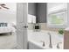 Relaxing bathroom with a large soaking tub, tiled walls, and view into the bedroom area at 1016 Pemberly Ave, Morrisville, NC 27560