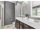 Stylish bathroom featuring a double vanity, sleek countertops, and a glass-enclosed shower at 1016 Pemberly Ave, Morrisville, NC 27560