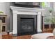 Modern fireplace with a sleek black surround and decorative mantel at 1016 Pemberly Ave, Morrisville, NC 27560