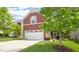 Two car garage with ample parking space, set against a lush lawn at 1016 Pemberly Ave, Morrisville, NC 27560