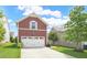 Spacious two-car garage with ample parking and a well-kept lawn at 1016 Pemberly Ave, Morrisville, NC 27560