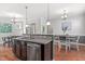 Open concept kitchen with stainless steel appliances and island seating at 1016 Pemberly Ave, Morrisville, NC 27560