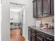 Stylish kitchen with dark cabinets, granite countertops and stainless steel appliances at 1016 Pemberly Ave, Morrisville, NC 27560