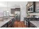 Modern kitchen featuring stainless steel appliances and granite countertops at 1016 Pemberly Ave, Morrisville, NC 27560