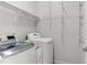 Clean laundry room equipped with modern washer and dryer, and wire shelving for ample storage at 1016 Pemberly Ave, Morrisville, NC 27560