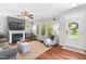 Bright and inviting living room with a fireplace, hardwood floors, and natural light at 1016 Pemberly Ave, Morrisville, NC 27560