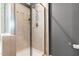 Modern bathroom features a glass-enclosed shower with tiled walls, neutral paint, and sleek hardware at 1016 Pemberly Ave, Morrisville, NC 27560