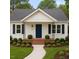 Charming single-story house with a manicured lawn, blue door, and black window shutters at 107 E Underwood Ave, Smithfield, NC 27577