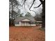 Exterior view of a quaint single-story home with a covered porch and mature trees at 107 E Underwood Ave, Smithfield, NC 27577