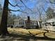 Backyard view with a deck and storage shed surrounded by mature trees at 110 Woodland Ridge Dr, Fuquay Varina, NC 27526