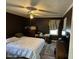 This is a bedroom with a ceiling fan, dark walls and a bed with white comforter at 110 Woodland Ridge Dr, Fuquay Varina, NC 27526