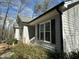 Close-up exterior view of the home featuring gray siding and black window shutters at 110 Woodland Ridge Dr, Fuquay Varina, NC 27526