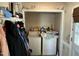 Functional laundry area with washer, dryer, and storage shelves at 110 Woodland Ridge Dr, Fuquay Varina, NC 27526