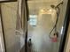 Modern bathroom shower featuring glass doors, and light gray marble-look tile at 110 Woodland Ridge Dr, Fuquay Varina, NC 27526
